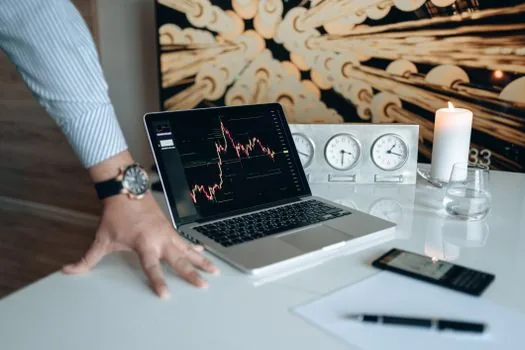 investor analyzing stock market chart laptop financial planning