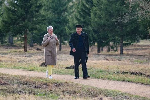 senior couple exercising walking park morning