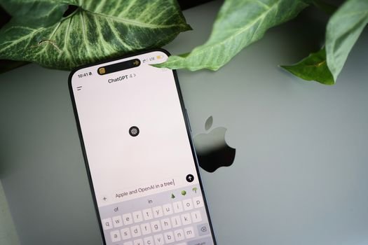 smartphone laptop screen showing OpenAI ChatGPT interface chat window