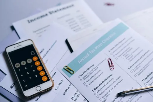 Korean online shopping receipt on smartphone with tax checklist and parcel box, realistic daylight