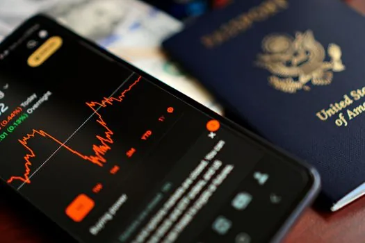 Korean passport renewal application on smartphone beside passport and photo file