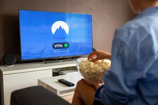 Korean viewer checking streaming subscription settings on TV and smartphone, evening living room light, realistic editorial scene