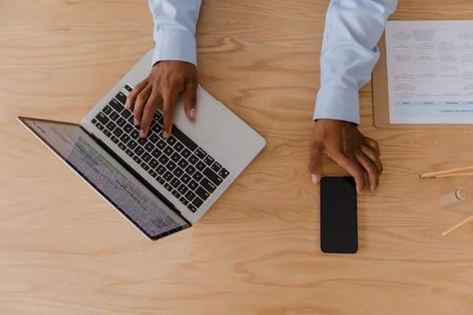 laptop showing privacy dashboard concept with smartphone map route and checklist, bright neutral desk, realistic editorial photo, no readable text