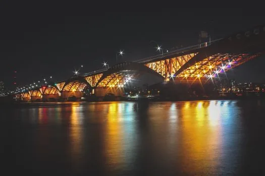 night road inspection on Seoul bridge ramp with asphalt surface opened, orange cones, engineers checking pavement, realistic editorial photo, no readable text