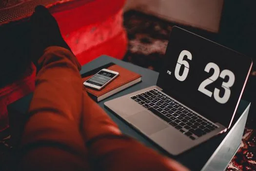 person checking laptop timer before sleep