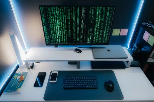 smartphone government app certificate code on desk with desktop computer
