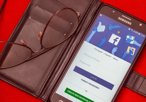 smartphone showing secure verification code notification beside laptop login screen