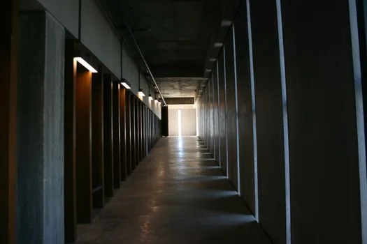 symbolic Korean radio studio hallway with empty visitor badge and warm light, no logos