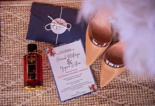 close-up of a wedding invitation dress code card on a table with elegant neutral outfits nearby, realistic editorial photo, no readable brand logos | 결혼식 초대장 복장 규정과 하객 의상 선택 장면