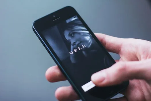 Korean commuter checking taxi ride history on smartphone after getting out of taxi, city street evening, clear phone and receipt folder | 택시 하차 뒤 카카오 T 이용기록을 확인하는 장면