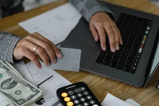 Korean user holding smartphone and ID card beside bank account verification memo, bright home desk, no real logos or personal data | 토스 인증서 발급 전 신분증과 본인 명의 계좌를 확인하는 장면