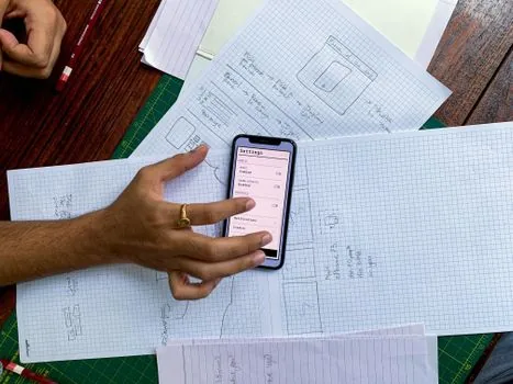 Korean user setting up digital certificate on a new smartphone with old phone, ID card case, and notebook checklist on a bright table