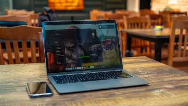 office desktop computer blocked by security policy with phone messenger verification nearby