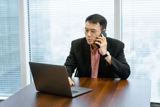 person checking blocked calls and notification settings on smartphone while government login page is open on laptop, bright practical help scene | 토스 인증 문자와 ARS 수신 차단 여부를 확인하는 장면