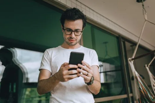 person checking email and phone verification code for social media account recovery
