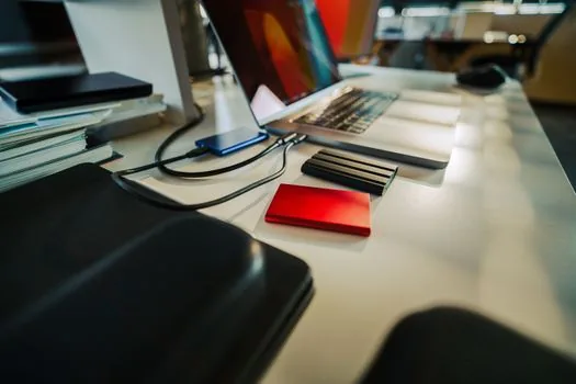 person selecting recent photo backup date on smartphone calendar beside organized photo album, realistic bright desk | 자동 올리기 시작 기준을 특정 날짜 이후로 바꾸는 장면