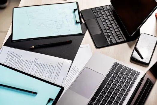real estate paperwork with building register, fee checklist, and smartphone authentication screen on clean Korean office desk