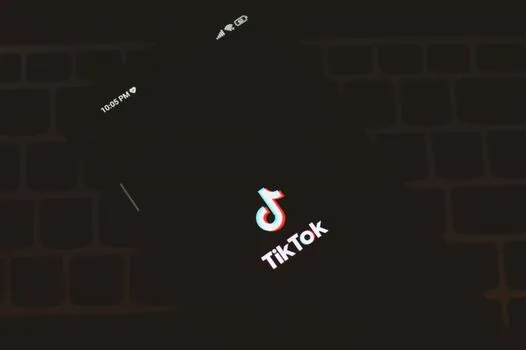 smartphone screen showing unavailable video thumbnail and brand campaign list blurred, Korean entertainment controversy context, realistic editorial photo
