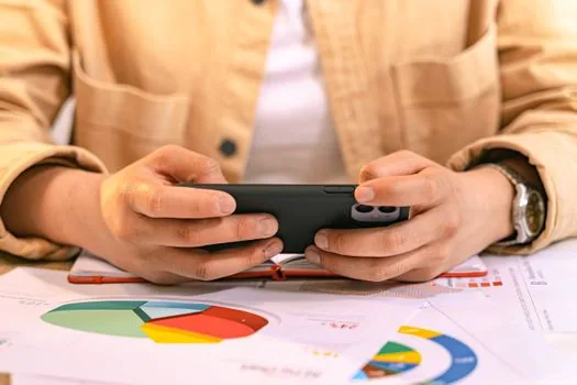 smartphone user reviewing Instagram account center privacy settings on a tidy desk