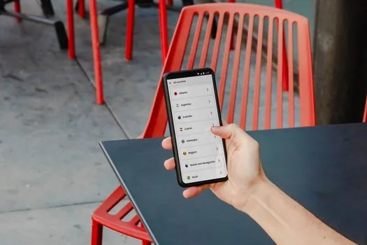 smartphone YouTube history settings screen blurred, Korean user deleting one watched video from activity list, realistic desk scene, no readable personal data | YouTube 시청 기록에서 특정 영상을 삭제하는 장면