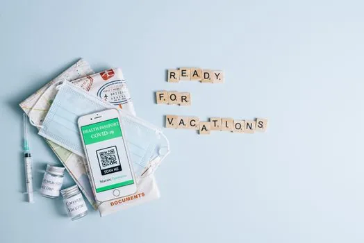 traveler selecting local digital tourism card region on smartphone with suitcase and printed itinerary nearby, realistic Korean travel planning scene | 여행 지역의 디지털 관광주민증을 선택하는 장면