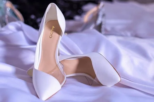 wardrobe selection with modest formal guest dresses, shoes, small clutch, wedding invitation on chair, soft natural light | 결혼식 하객룩을 고르기 전 옷장과 초대장을 함께 확인하는 장면
