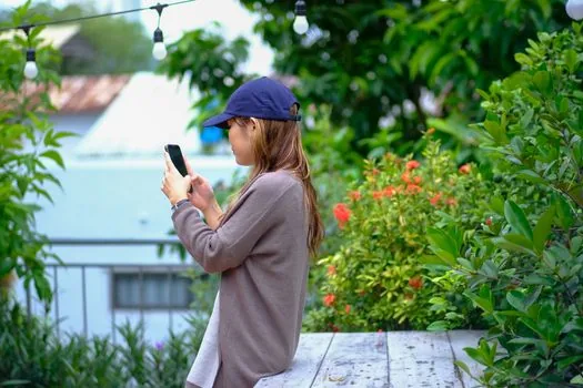 Korean family checking UV index on smartphone before going outside, sunscreen hat long sleeve shirt on entryway table, realistic bright home scene