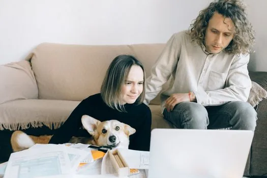 Korean family preparing pet ownership transfer documents with dog registration number and phone memo | 소유자 변경 전 기존 등록번호와 이전 보호자 정보를 맞춰보는 장면