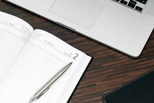 Korean freelancer reviewing annual service contract, work schedule calendar and message records at a quiet desk, realistic documentary photo, no logos