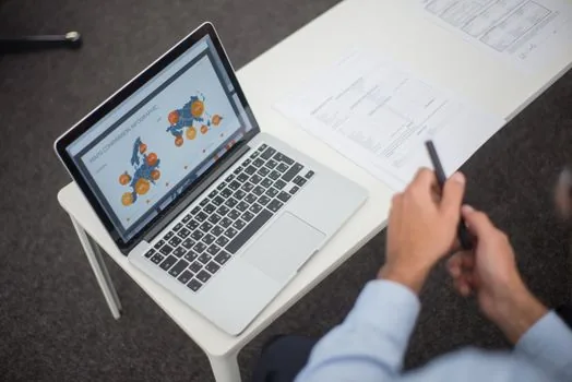 Korean person checking civil certificate submission checklist beside laptop and printed documents, bright desk, realistic editorial photo, no readable personal data