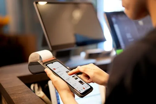 Korean person comparing health record app screen with hospital receipt and prescription bag on a desk, clean daylight, realistic editorial photo