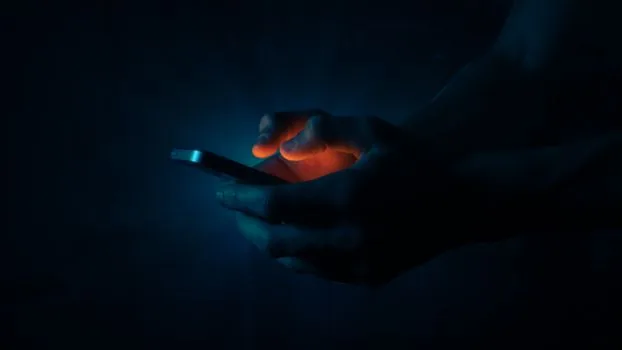 Korean person searching nearby emergency hospital on smartphone at night, map interface glow, realistic healthcare documentary photo, no logos