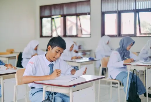 Korean teenager preparing a passport style photo and application form on a clean desk, local community center atmosphere, realistic bright photo