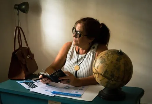 Korean traveler comparing passport English name with driver license and application form, realistic bright desk photo