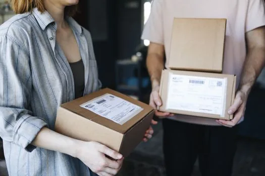 Korean user measuring a parcel box near apartment doorway before post office pickup, realistic lifestyle photo, no logo