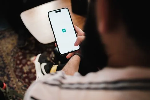 smartphone wellness app step counter syncing with health app beside walking shoes and water bottle, Korean home setting, realistic editorial photo, no brand logos or readable data | The건강보험 앱 걸음 수 연동을 확인하는 장면