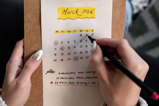 calendar with travel dates highlighted, child passport, school document request paper, careful checklist on desk