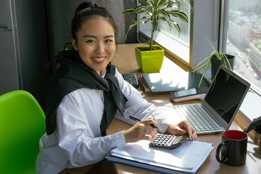 consultant and Korean business owner checking M&A due diligence checklist, accounting folders and calculator on bright office desk, realistic photo | 기업승계 M&A 실사 체크리스트와 비용 지원 항목을 확인하는 장면