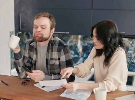 family member reviewing hospital bill, installment repayment notice and calendar on kitchen table