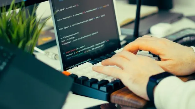 close up of Windows laptop user choosing ClearType text samples beside external monitor, realistic bright desk photo