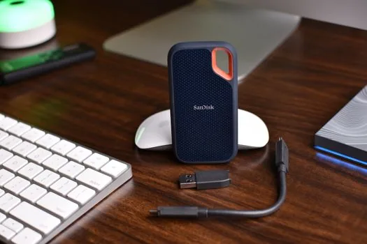 Google Photos style gallery thumbnails and cloud backup warning on smartphone beside external drive, realistic home desk photo, no logos