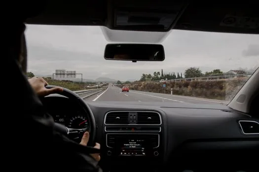 Korean driver viewpoint inside tunnel slowing down safely behind unexpected cones and stopped vehicle, realistic dashboard perspective