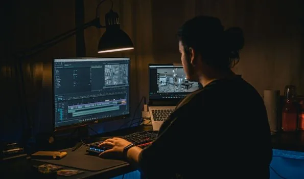 Korean editor reviewing celebrity religion controversy video timeline on laptop