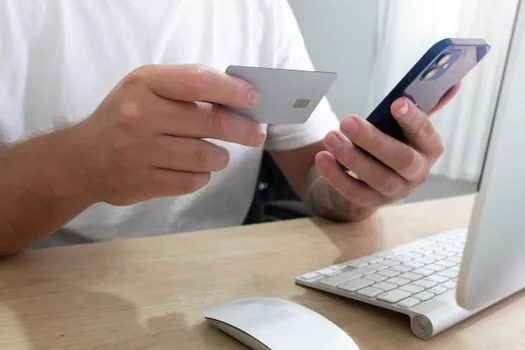 Korean person checking utility bill due date and automatic payment memo on smartphone, realistic finance desk