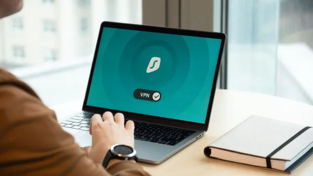 Korean user checking official Telegram Desktop download page on laptop beside smartphone, clean desk, bright realistic photo, no readable private data