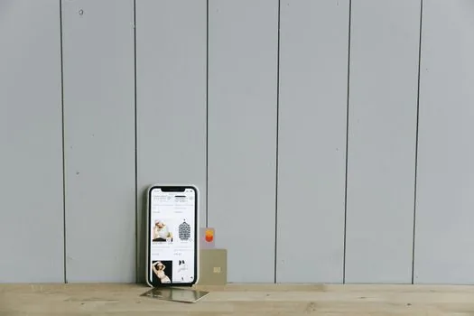 Korean user opening official cardpoint website on smartphone with credit cards on table, realistic close-up, no visible logos, no text overlay