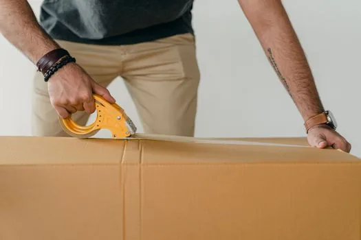 packed parcel on scale with measuring tape showing length width height, Korean home desk, realistic parcel preparation photo | 소포 무게와 세 변 합을 함께 확인하는 장면