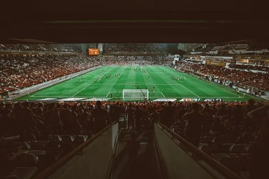 Seoul World Cup Stadium evening match preview with football schedule cards, Korean fans preparing scarves, realistic sports photo | 우루과이전을 앞두고 다음 평가전 일정을 확인하는 장면