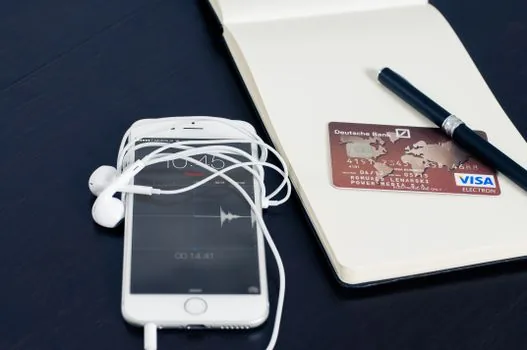 Smartphone bank account notification after points deposit with credit card and coffee on desk, realistic photo, no logos, no text overlay