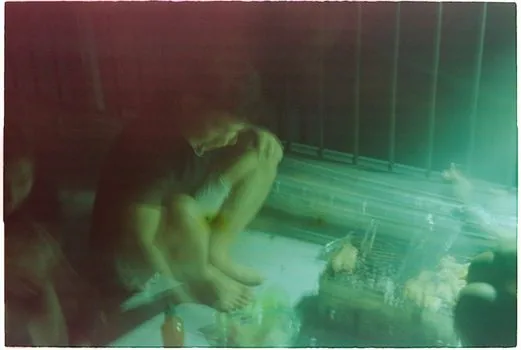Korean family cooling a heat illness patient with wet towels and ice packs under shade while emergency call is being made, realistic summer public health scene | 열사병 의심 환자를 그늘에서 식히며 119 신고를 하는 장면